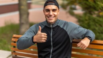 a motivated man with a smile and a thumbs-up